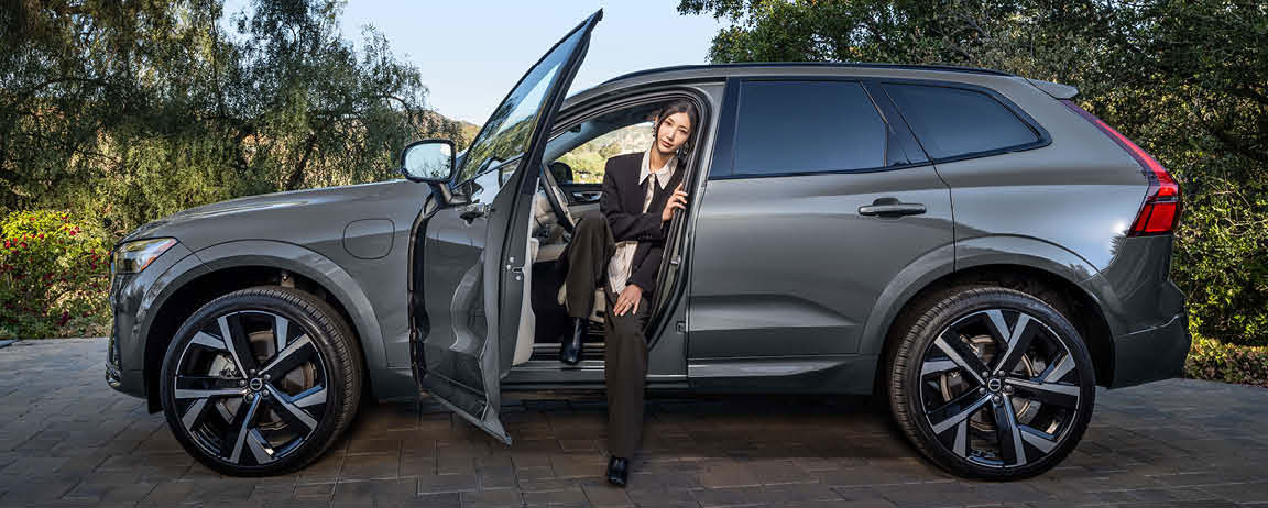 Woman entering Volvo XC60 showcasing easy access and premium interior