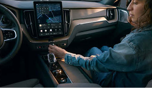 Volvo XC60 center console with driver adjusting controls and touchscreen