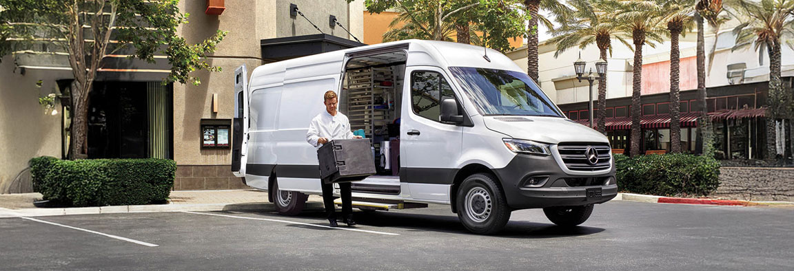 Mercedes-Benz Sprinter cargo van parked curbside while driver unloads supplies for local business deliveries