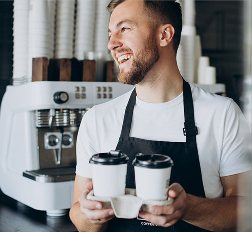 barista carrying coffee cups inside a café, representing mobile business and delivery services