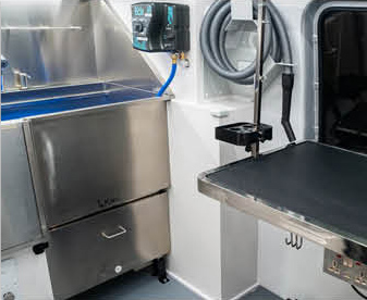 Close-up of pet grooming equipment and wash station inside Sprinter van