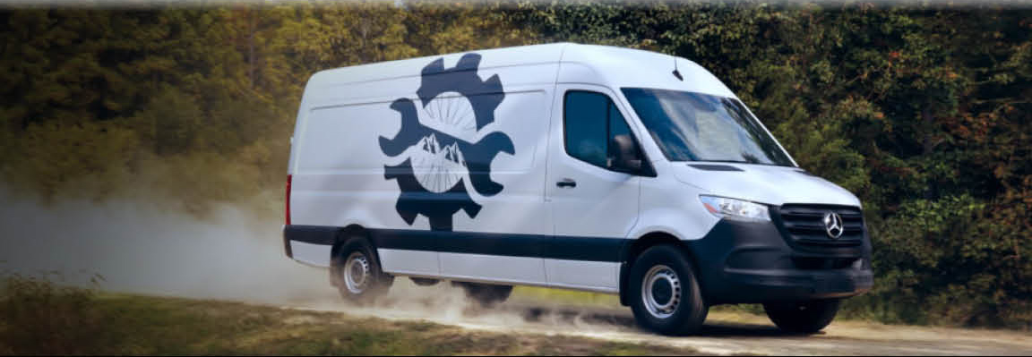 Mercedes-Benz Sprinter work van driving on a dirt road for service operations