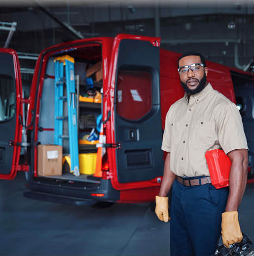 Service technician standing next to a fully equipped work van with tools