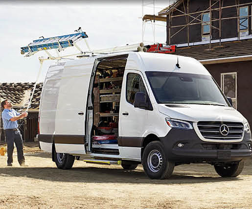 Mercedes-Benz Sprinter work van with ladder rack at a construction site