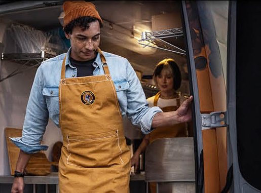 Small business owners operating a mobile food business from a van