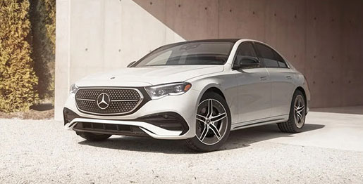 White Mercedes-Benz sedan parked in modern architectural setting