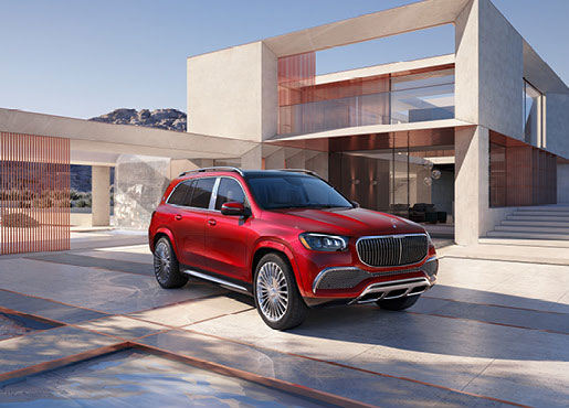 Mercedes-Maybach GLS luxury SUV in red parked in front of contemporary house