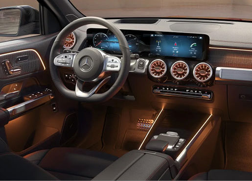 Mercedes-Benz interior with digital cockpit, ambient lighting, and premium materials