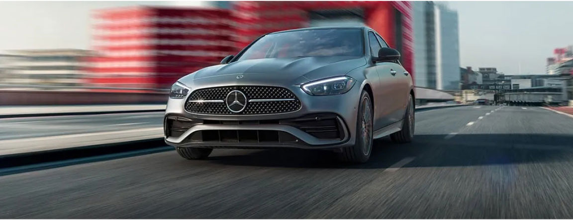 Mercedes-Benz sedan driving in city with sleek design and advanced performance