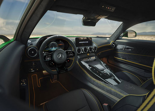 Mercedes-AMG sports car interior with performance steering wheel and center console