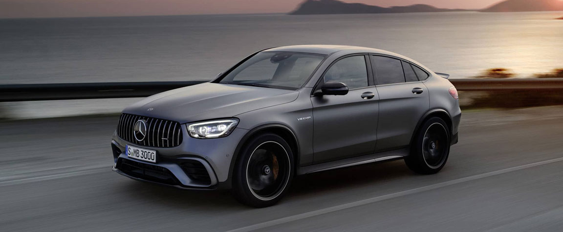 Mercedes-AMG performance SUV driving along a coastal road