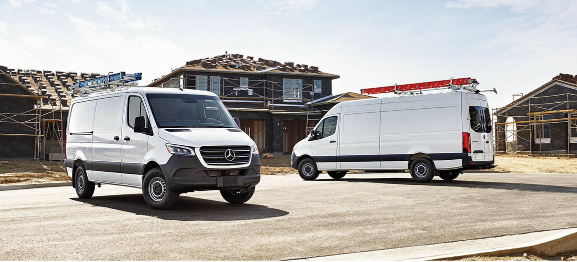 Mercedes-Benz Sprinter cargo vans parked at residential construction site with ladder racks