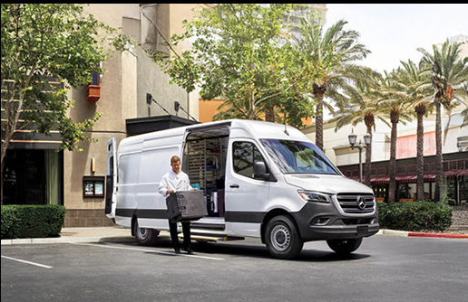 Mercedes-Benz Sprinter cargo van with technician unloading equipment in city setting