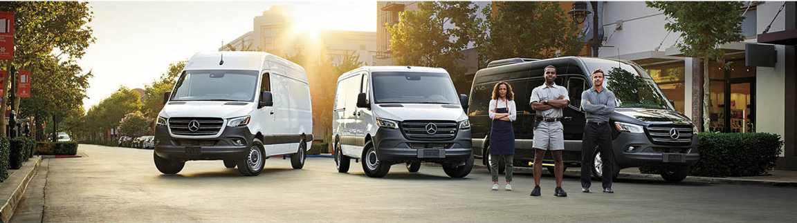 Mercedes-Benz Sprinter vans with commercial team standing in urban business district