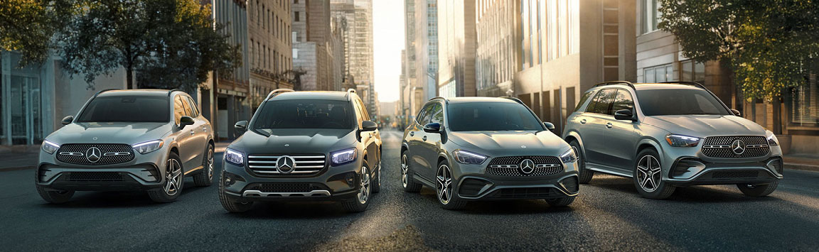 Mercedes-Benz SUV lineup parked on downtown city street at sunset