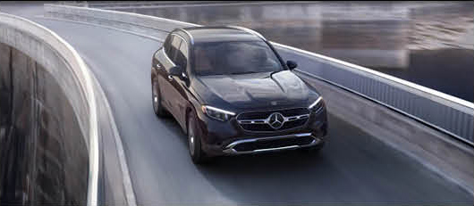 Mercedes-Benz GLC SUV driving on a modern highway bridge