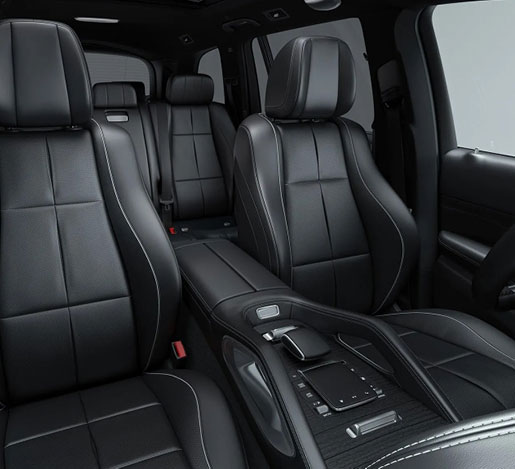 Mercedes-Benz GLS interior with black leather seating, premium center console, panoramic sunroof and spacious three-row luxury cabin.