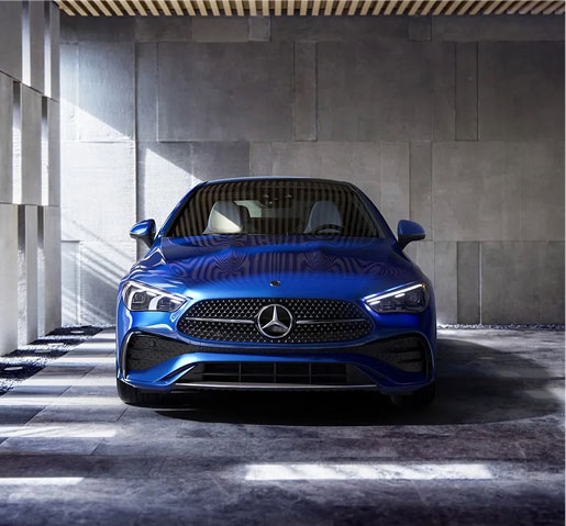 Front view of a blue Mercedes-Benz CLA, highlighting LED lighting, diamond-pattern grille, and contemporary luxury styling