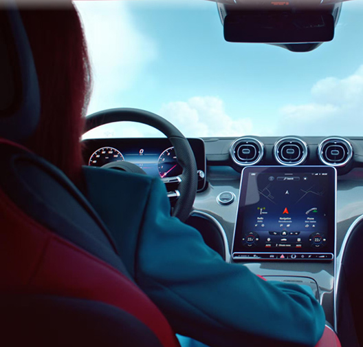 Driver using Mercedes-Benz vehicle touchscreen infotainment system