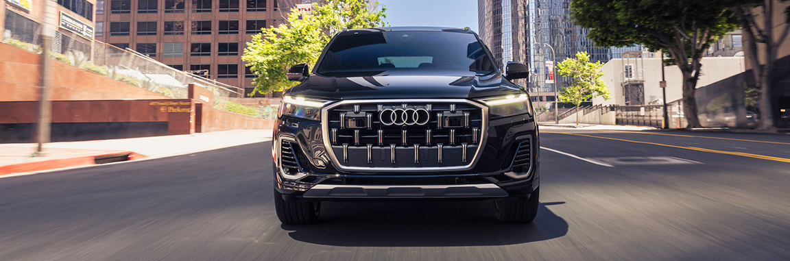 2025 Audi Q7 luxury SUV driving through scenic countryside