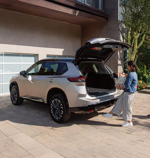 Nissan Rogue SUV with power liftgate open while loading groceries at home