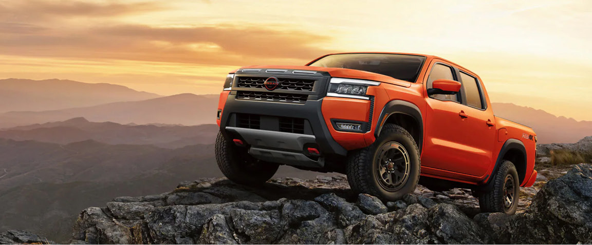 Nissan Frontier PRO-4X parked on rocky mountain terrain at sunset