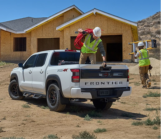 White Nissan Frontier pickup truck being used at a construction job site