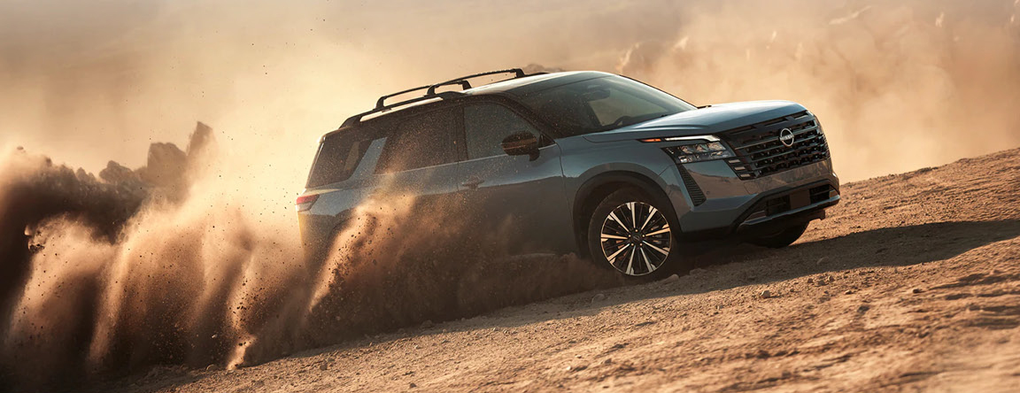 Nissan Pathfinder driving through desert terrain demonstrating confident performance and adventure-ready capability