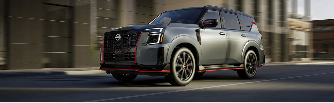 Nissan Armada driving in city with bold design and sporty accents