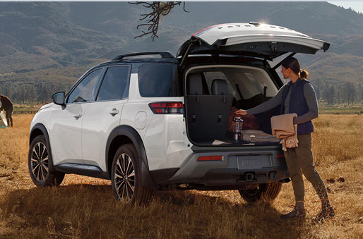 Nissan Pathfinder SUV with open cargo area during outdoor adventure trip