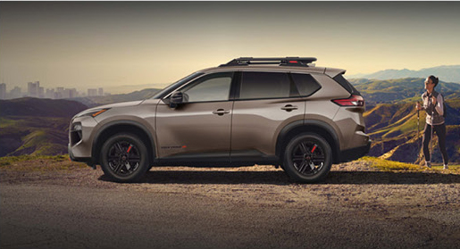 Nissan Rogue Rock Creek SUV parked at a mountain viewpoint with outdoor adventure gear