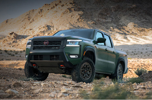 gray Nissan Frontier PRO-4X pickup truck driving across rocky desert terrain