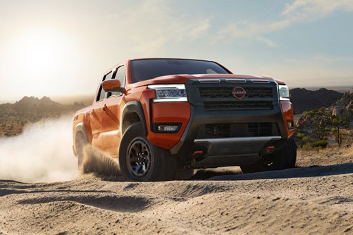 Nissan Frontier PRO-4X driving through desert terrain showcasing rugged performance and confidence on unpaved roads