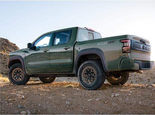 Nissan Frontier PRO-4X rear three-quarter view showcasing rugged off-road styling, all-terrain tires, and adventure-ready capability