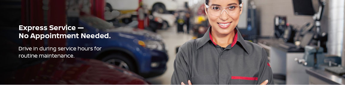 Nissan Express Service technician smiling in the service center