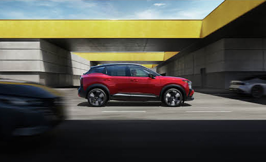 Nissan Kicks subcompact SUV driving through a modern city underpass