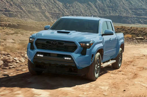 Toyota Tacoma truck driving on rocky desert trail with rugged terrain capability