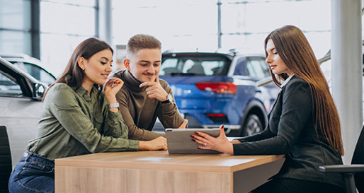 Couple discussing vehicle financing options with a dealership representative