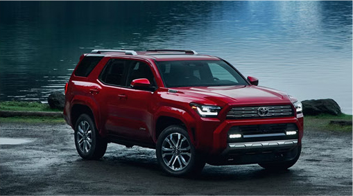 red Toyota 4Runner SUV parked near a lakeside recreation area