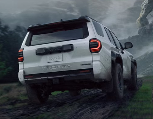 white Toyota 4Runner TRD Pro SUV driving through rocky off-road terrain