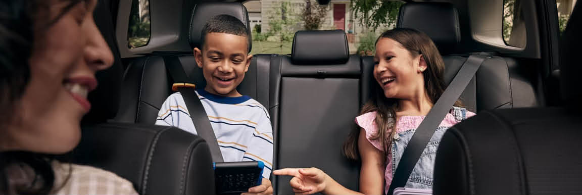 Toyota Highlander interior with kids riding safely in the back seat
