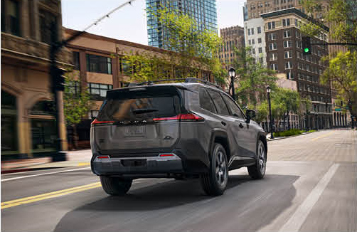 Toyota bZ4X electric SUV driving through a modern city street