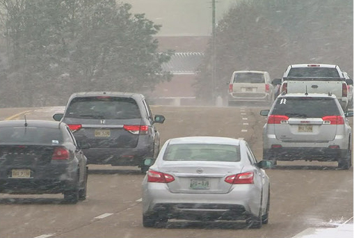 Vehicles driving through heavy rain conditions illustrating the importance of safety features and driver confidence