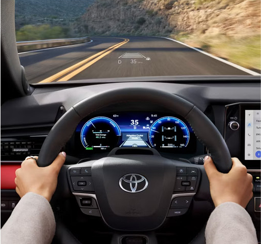 Driver's view of Toyota Camry digital instrument cluster with head-up display and advanced driver-assistance technology