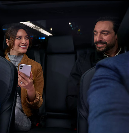 Rear-seat passengers enjoying a comfortable ride in the Toyota Camry with spacious interior accommodations