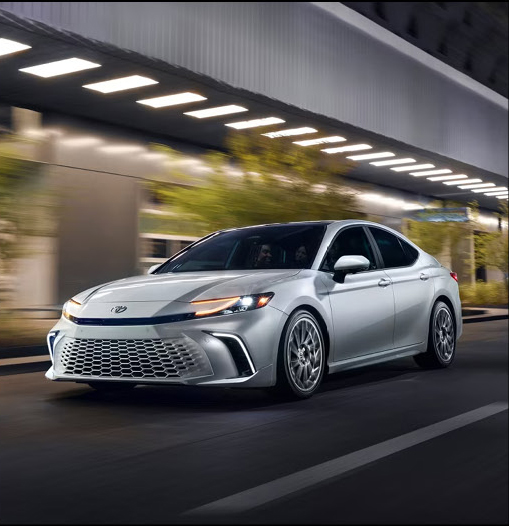 Toyota Camry nighttime driving scene featuring modern exterior styling and LED lighting technology