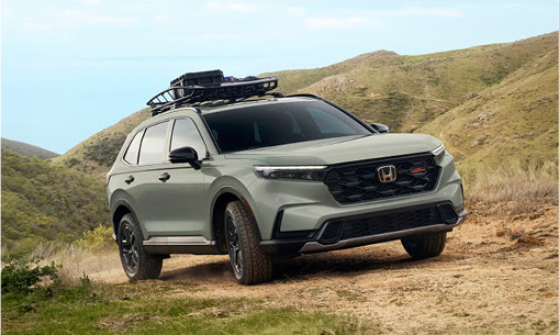Honda CR-V TrailSport SUV parked on a rugged mountain trail with roof rack cargo