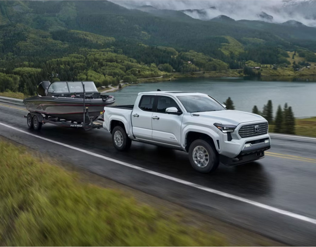 a Toyota Tacoma hauling a boad on the highway