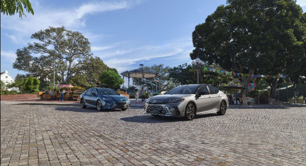 Toyota Camry sedans driving through a public plaza in an urban setting