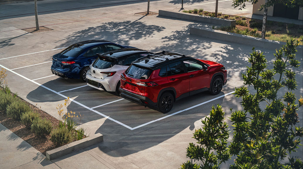 Toyota Corolla Cross and Toyota Corolla hatchback parked side by side in a parking lot